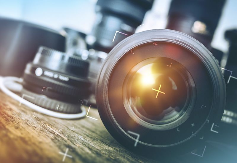 a close up image of a camera lens with another one shown in the background